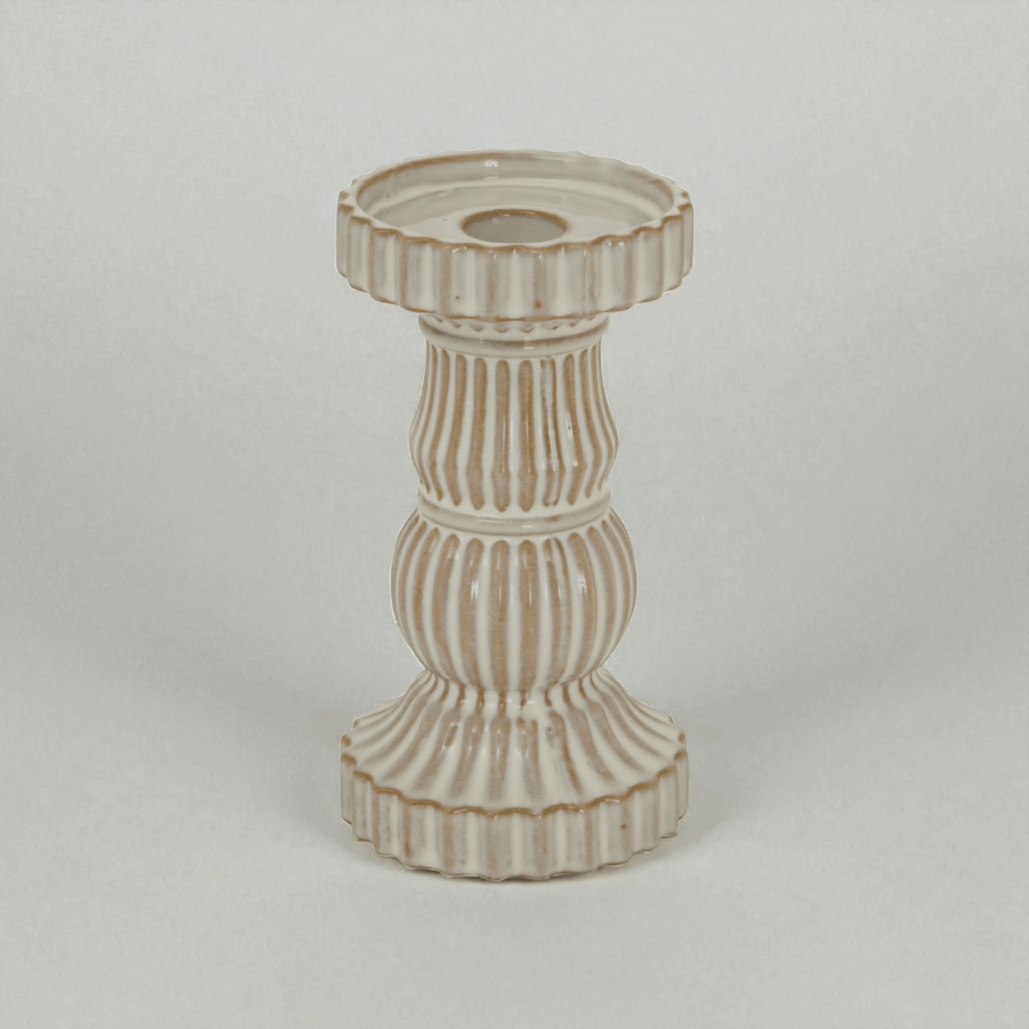 Alora ceramic pillar candle holder in white, showcasing ridged design for elegant display and ambient light effects.