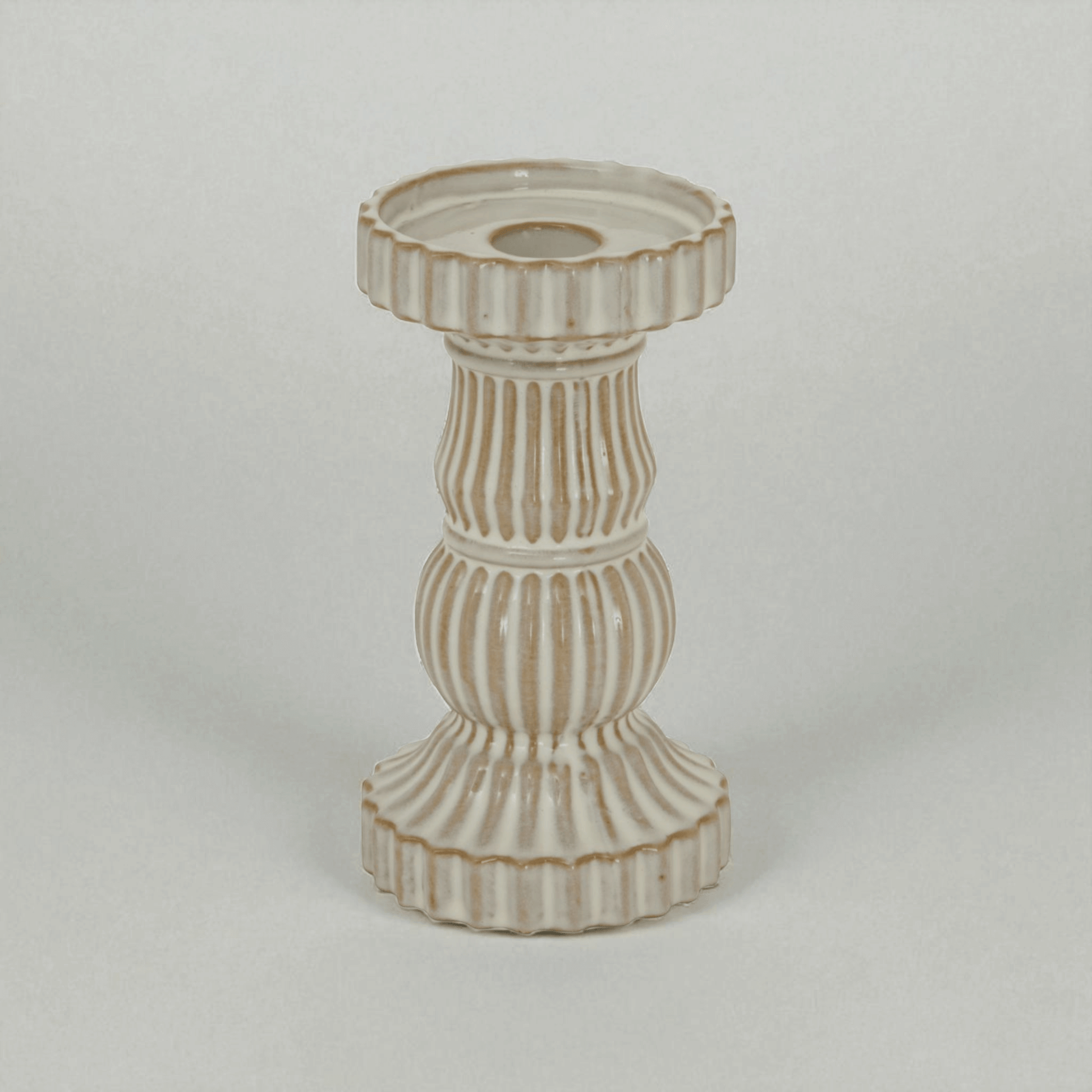 Alora ceramic pillar candle holder in white, showcasing ridged design for elegant display and ambient light effects.