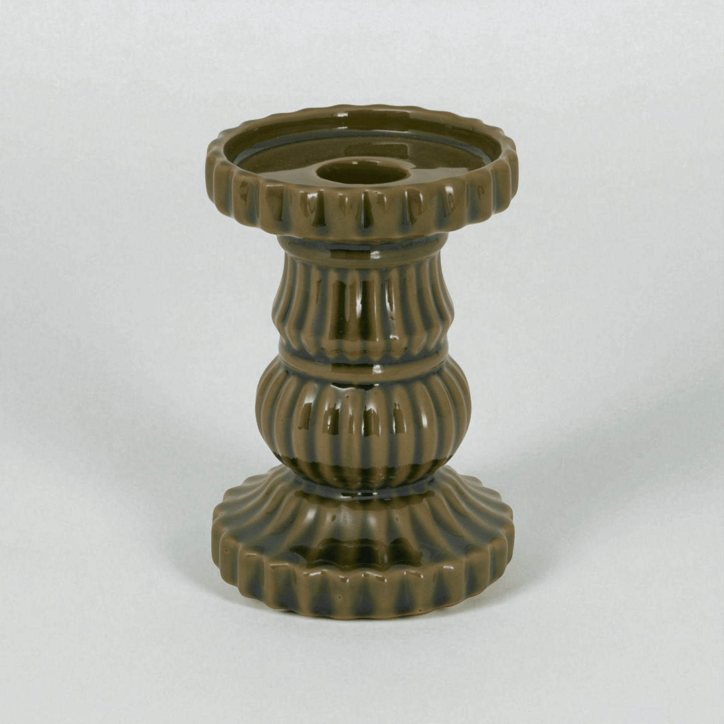 Contemporary olive ceramic pillar candle holder, perfect for modern decor, adding Mediterranean charm to any room.