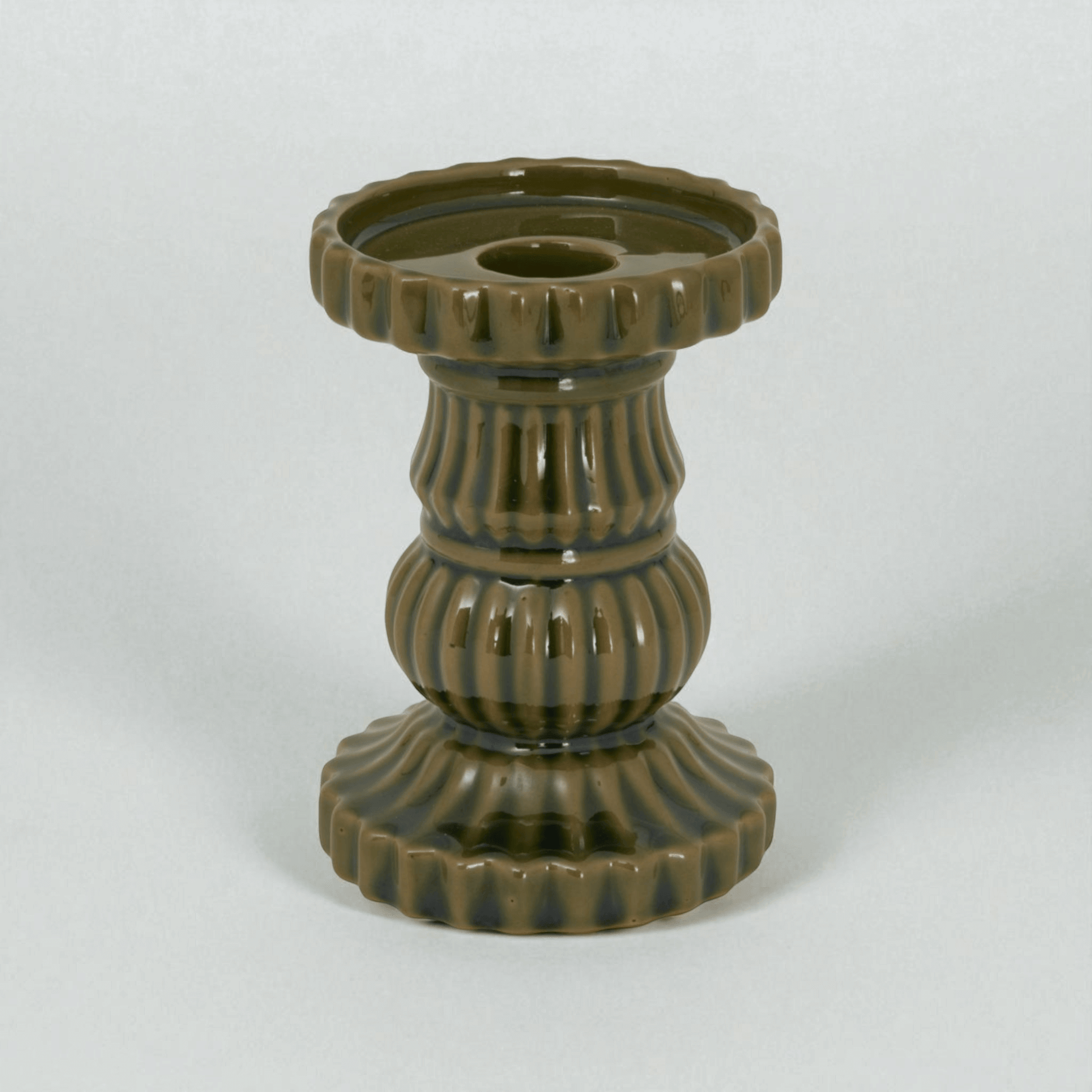 Contemporary olive ceramic pillar candle holder, perfect for modern decor, adding Mediterranean charm to any room.